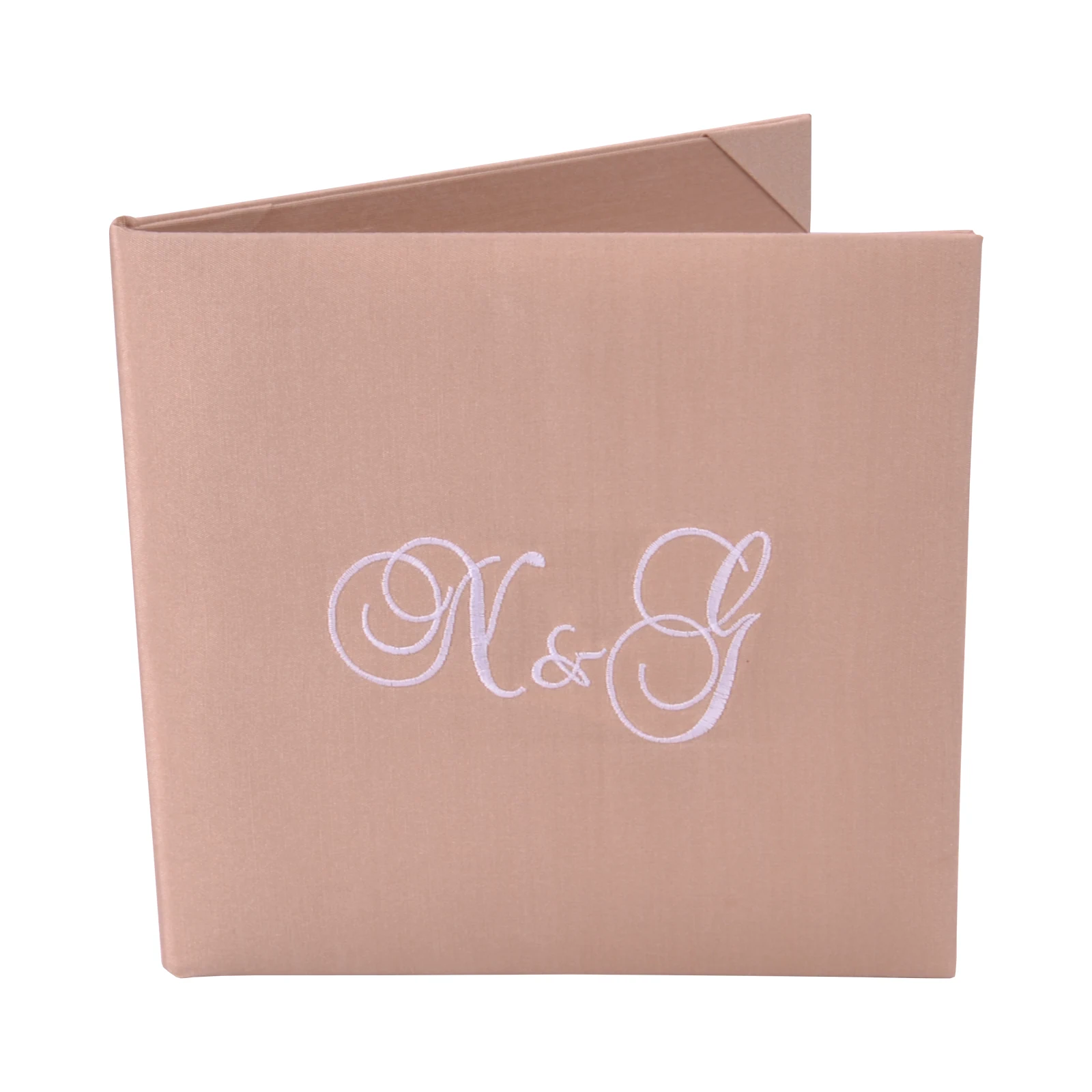 Champagne-toned silk book folio with pale embroidered initials, shown partly open