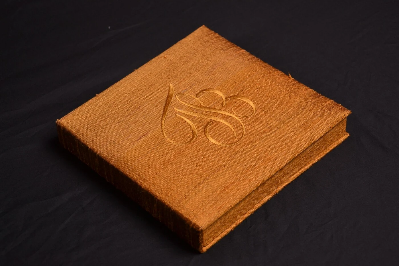 Burnt orange silk wedding invitation box with embroidered monogram for autumn wedding ideas