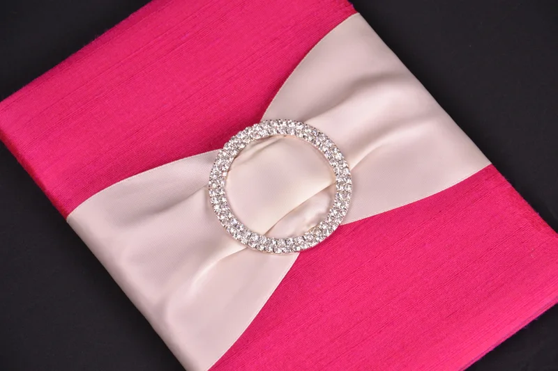 Fuchsia invitation fabric with a pale ribbon and circular crystal buckle
