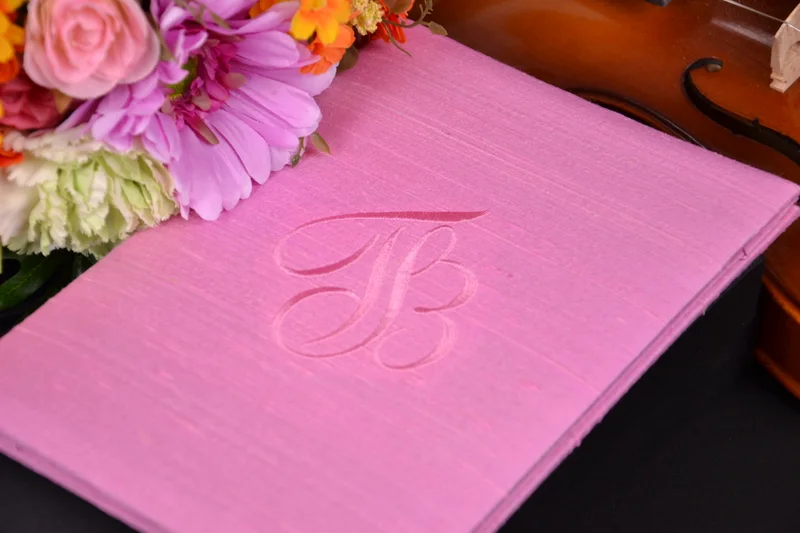 Pink invitation box with tonal embroidered initials and floral styling