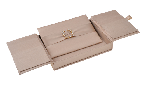 Taupe gatefold silk invitation box with a matching ribbon and crystal embellishment