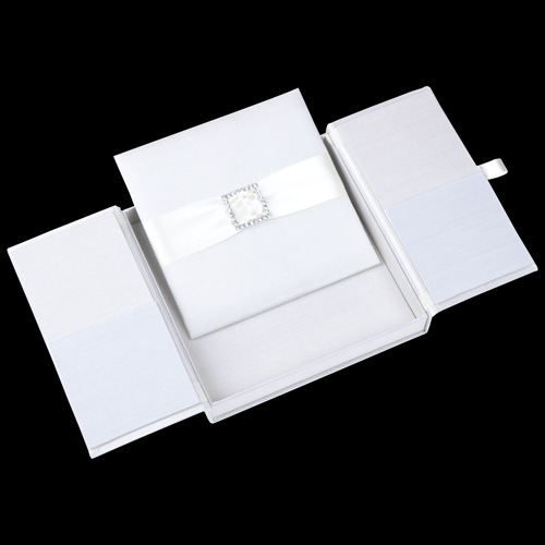 White silk gatefold invitation box with a ribbon and crystal detail on the inner panel