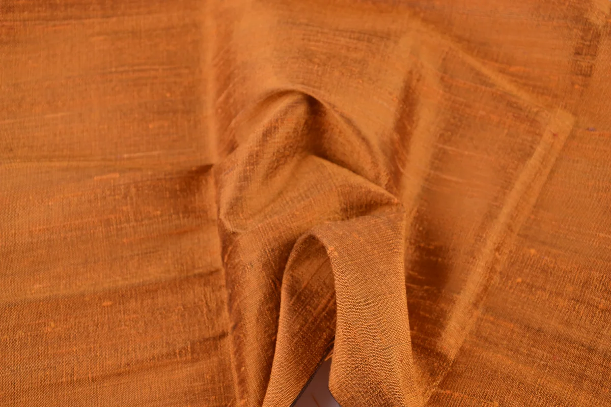 Golden orange handwoven Thai dupioni silk with its textured surface and natural slubs
