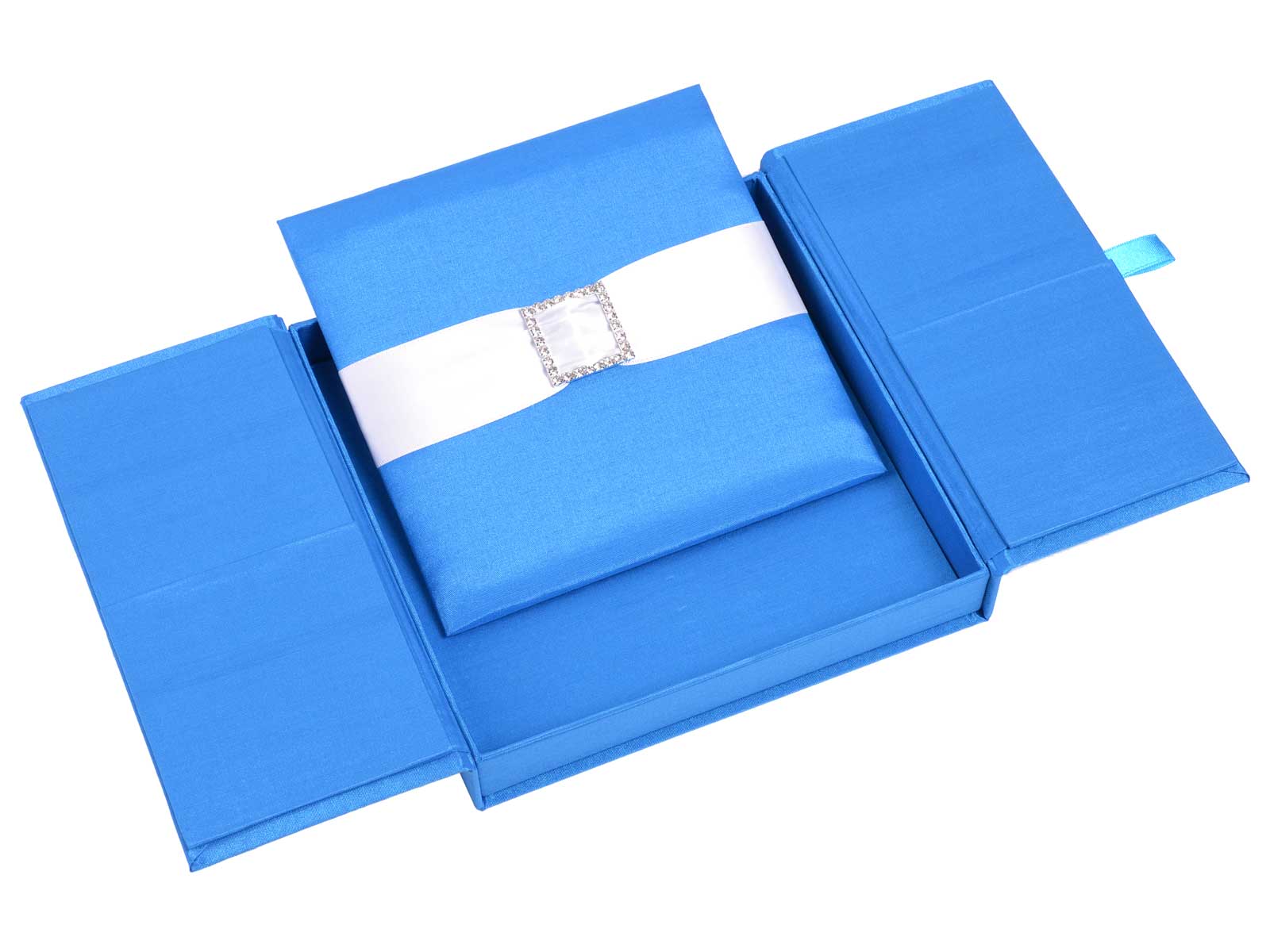 Open blue silk gatefold invitation box with a matching insert, white ribbon and square jeweled embellishment