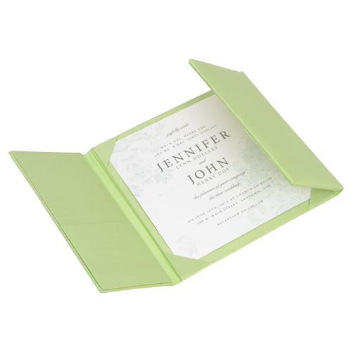 Pale green silk gatefold wedding invitation folio opened to reveal a custom invitation