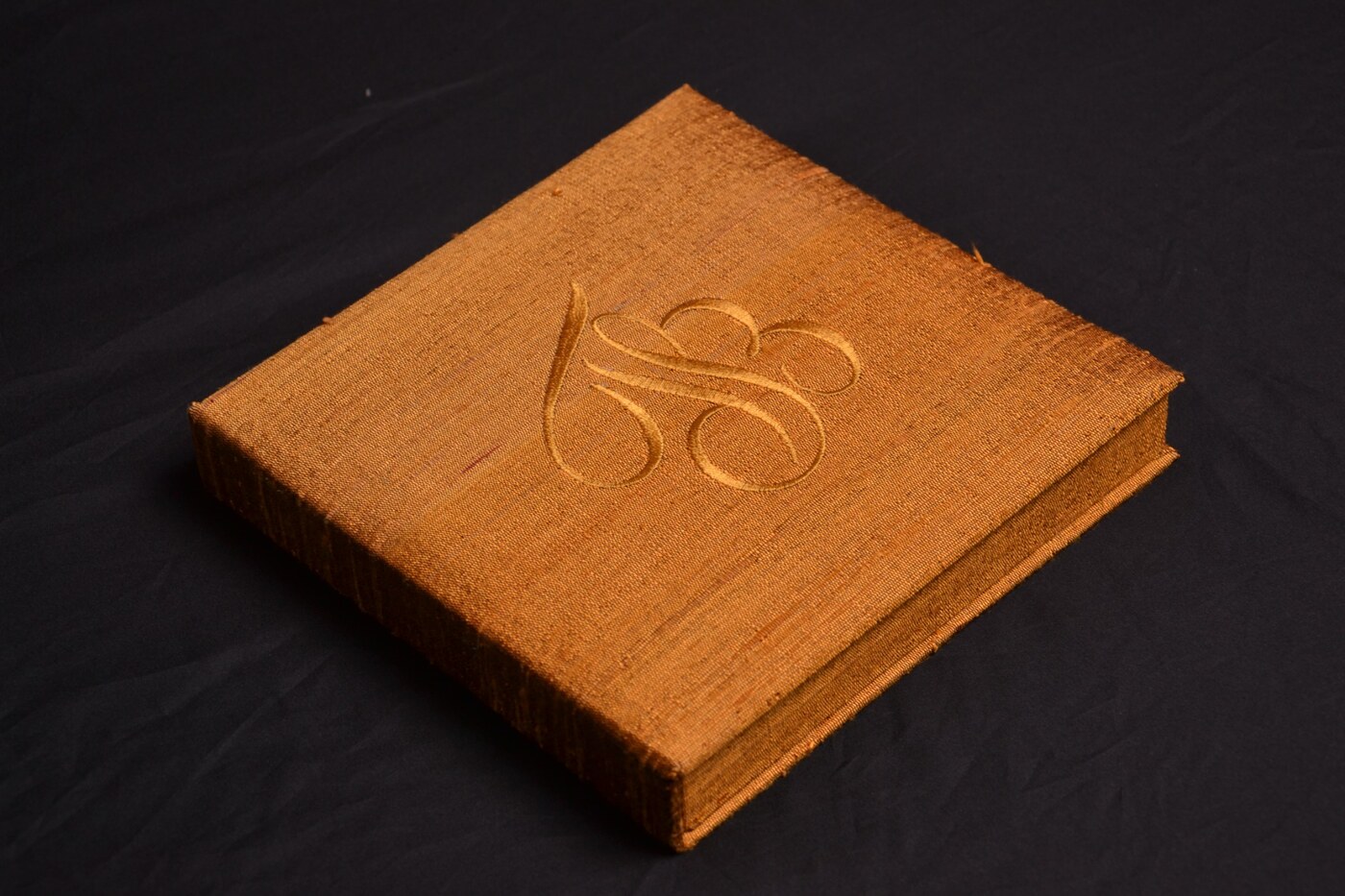 Burnt orange silk wedding invitation box with embroidered monogram for autumn wedding ideas