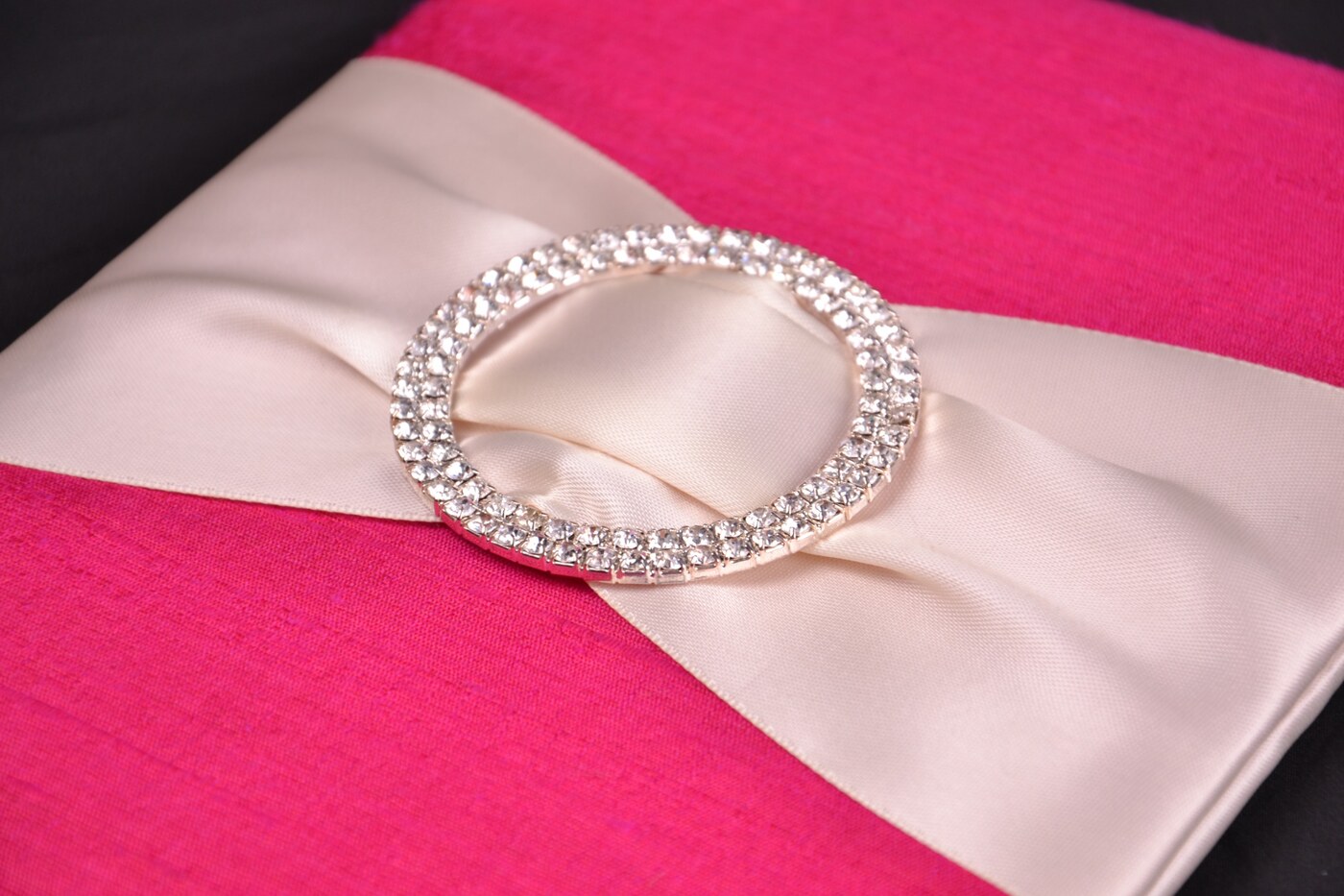 Fuchsia silk wedding invitation box with pearl ribbon and circular crystal buckle